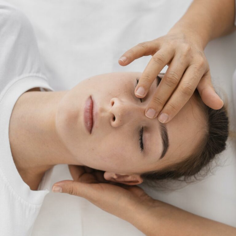 Osteopathist treating patient by massaging her face 1 1024x1024